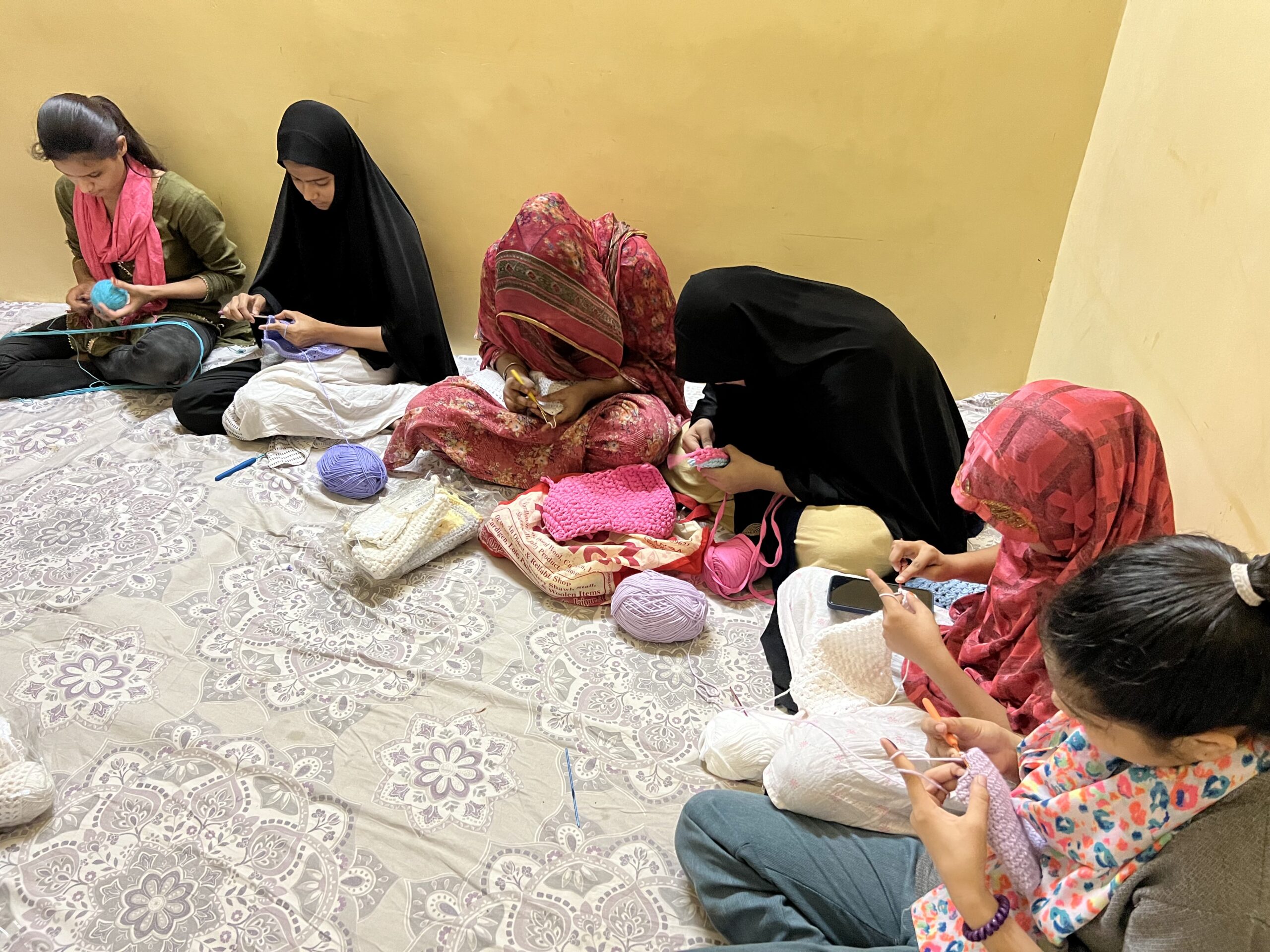 Women and Girls learning crochet skills at The Project Together initiative by Dr. Samra Sultana